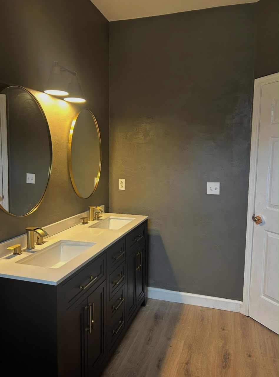 Dark moody bathroom with dual vanity