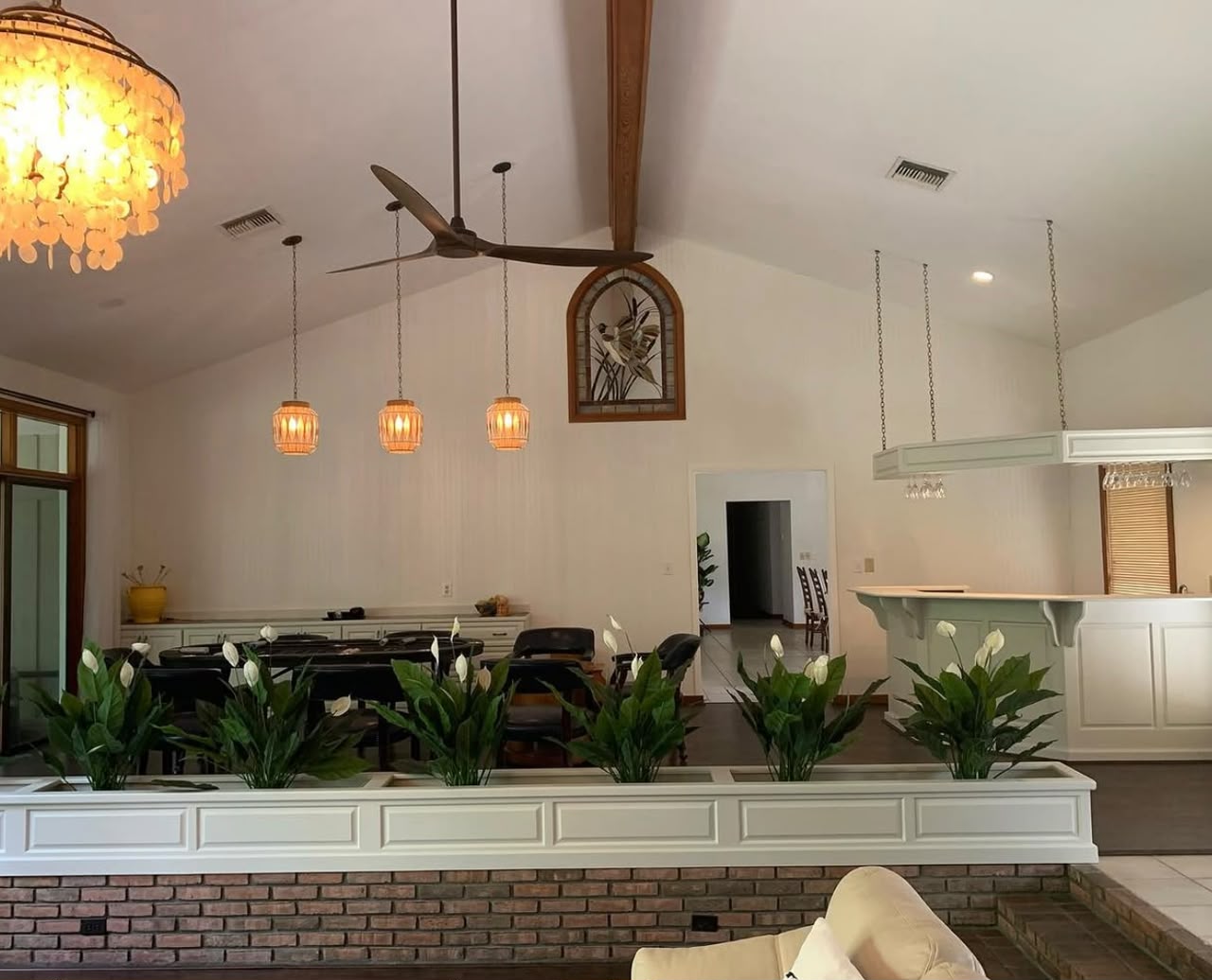 Open-plan living and dining room with crystal pendants