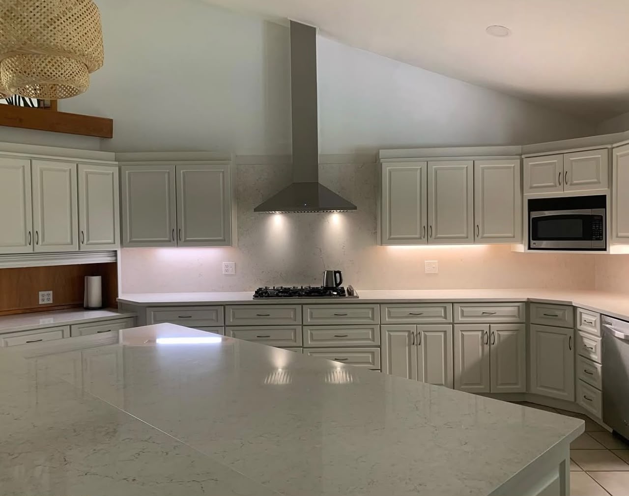 Kitchen remodel with sage cabinets and quartz island