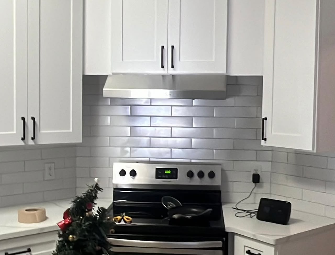 White kitchen with stainless subway tile